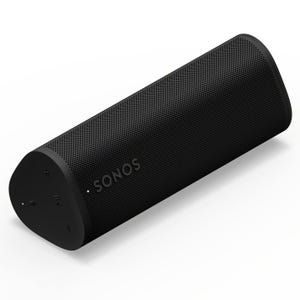 The Sonos Roam 2 is a compact, cylindrical portable speaker with a matte black finish, featuring button controls on one end, perforated grille design, and the Sonos logo on the side for wireless audio connectivity.