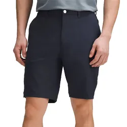 A person is wearing dark-colored knee-length shorts paired with a light-colored shirt.