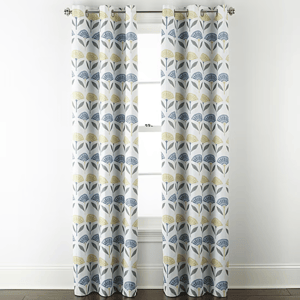 Pair of curtains with a modern floral pattern featuring blue and yellow stylized flowers on a white background, hanging on a metal rod.