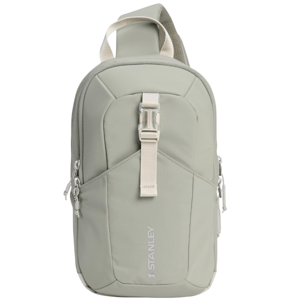 Sage green crossbody sling bag with a central buckle strap and dual zippers, featuring \“Stanley\“ branding on the front.