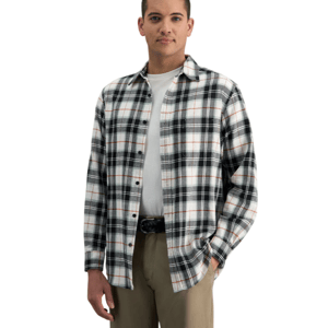 A man is wearing a plaid button-up shirt in black, white, and orange over a white T-shirt, paired with khaki pants and a black belt.