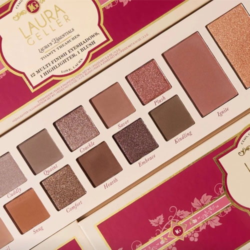 Laura Geller's Toasty Treasures Palette includes 19 multi-finish eyeshadows, 1 highlighter, and 1 blush, featuring shades like Cuddly, Quaint, Crackle, and Ignite, in a warm color scheme with shimmering and matte finishes.