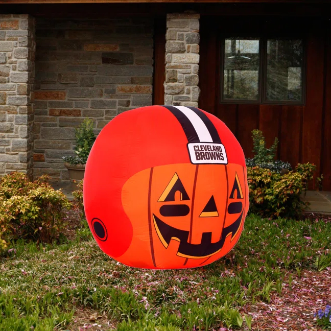An inflatable Halloween decoration shaped like a pumpkin, featuring the Cleveland Browns football team logo.