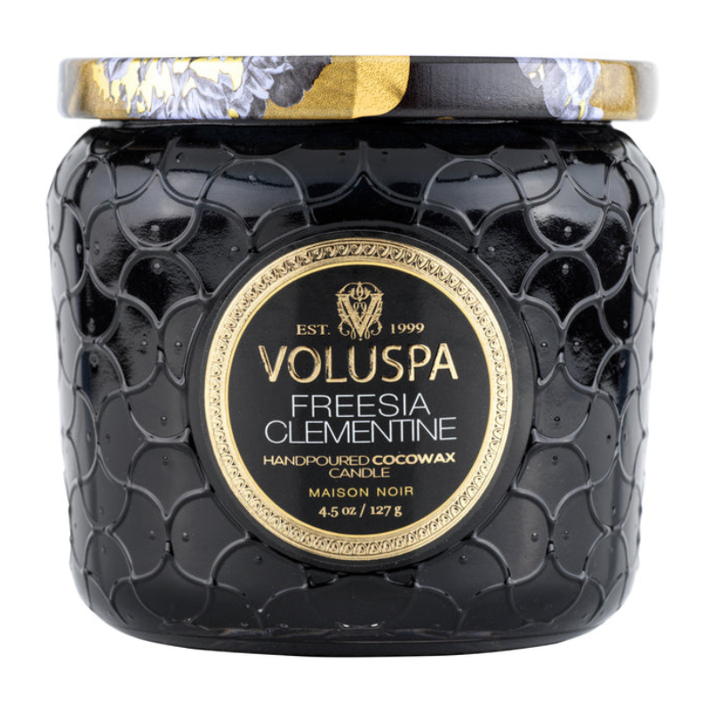 Voluspa Freesia Clementine hand-poured cocowax candle, Maison Noir collection, 4.5 oz (127 g), in a textured black jar with an ornate lid design.