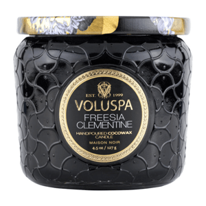 Voluspa Freesia Clementine hand-poured cocowax candle, Maison Noir collection, 4.5 oz (127 g), in a textured black jar with an ornate lid design.