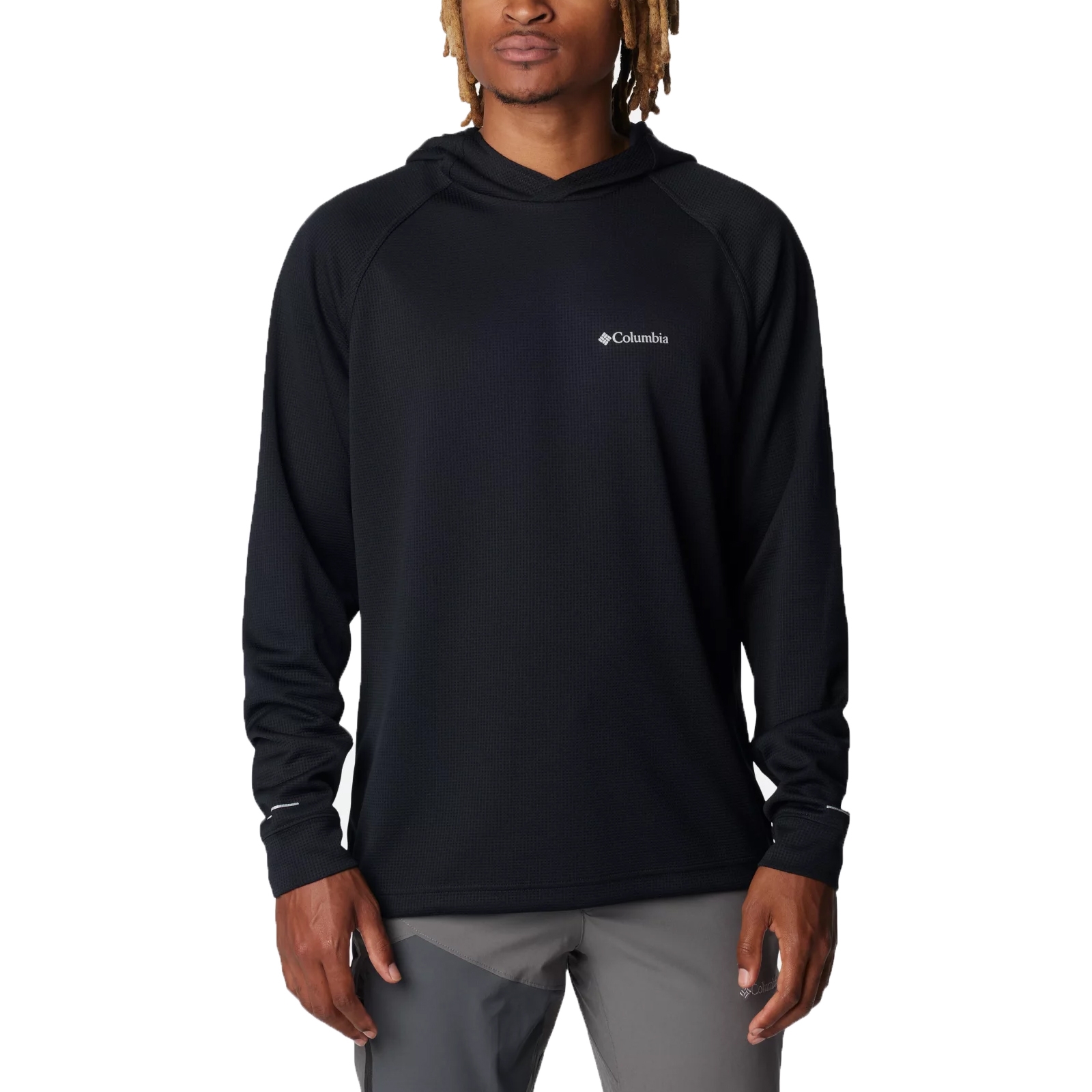A person is wearing a black Columbia hoodie with a small logo on the chest, paired with gray pants.