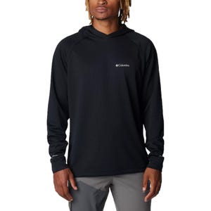 A person is wearing a black Columbia hoodie with a small logo on the chest, paired with gray pants.