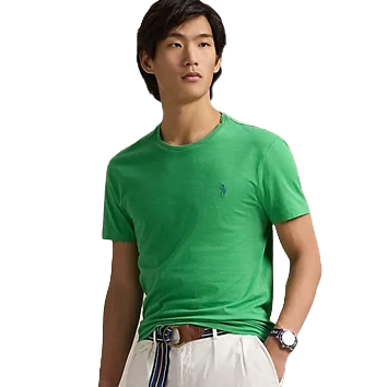 A person is wearing a green short-sleeve t-shirt paired with white pants, featuring a striped belt and a watch.