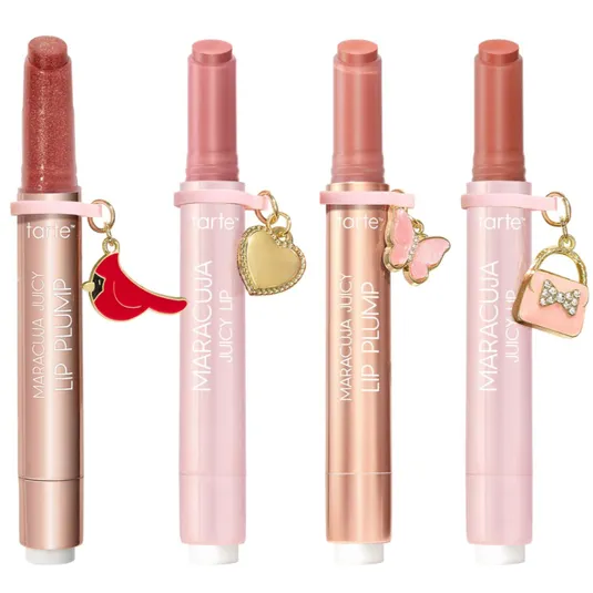 Four Tarte Maracuja Juicy Lip Plump products in various shades, each featuring a unique charm: a cardinal, a heart, a butterfly, and a handbag.