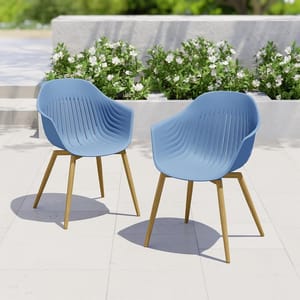 Two blue modern outdoor chairs with wooden legs set on a patio.