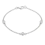 A delicate silver bracelet with a chain design featuring three evenly spaced round clear gemstones and a lobster clasp closure.