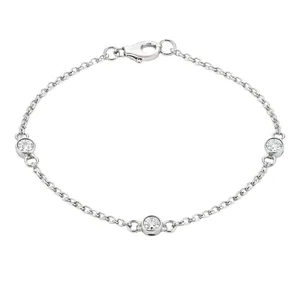 A delicate silver bracelet with a chain design featuring three evenly spaced round clear gemstones and a lobster clasp closure.