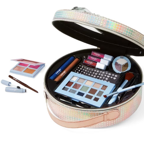 a round iridescent case filled with cosmetics