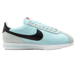 Light blue Nike Cortez sneaker with a black swoosh, white sole, and grey suede accents.