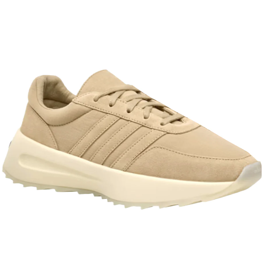 A beige sneaker with a thick, off-white sole and three parallel stripes on the side, featuring a lace-up design.