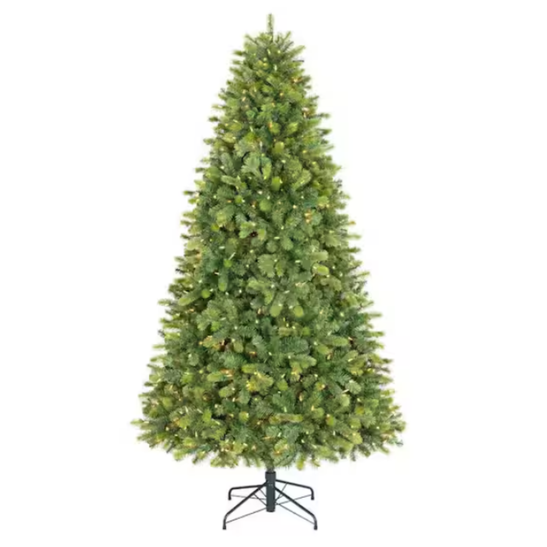 Artificial Christmas tree with dense green foliage and a metal stand.