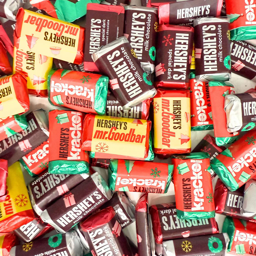 Assorted Hershey's Miniatures candies with wrappers featuring designs for Milk Chocolate, Special Dark, Krackel, and Mr. Goodbar, decorated in festive holiday colors and patterns.
