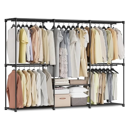 A freestanding wardrobe with a metal frame features clothing on hangers, multiple storage shelves, folded clothes, and boxes.