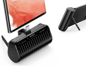 A portable battery pack with a built-in phone stand and LED charge indicators, alongside a smartphone with a matching kickstand case.