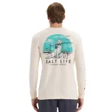 A long-sleeve shirt featuring a \“Salt Life Fishing Buddy\“ graphic, depicting a dog on a boat with a fishing rod and bucket, against a turquoise circular background.