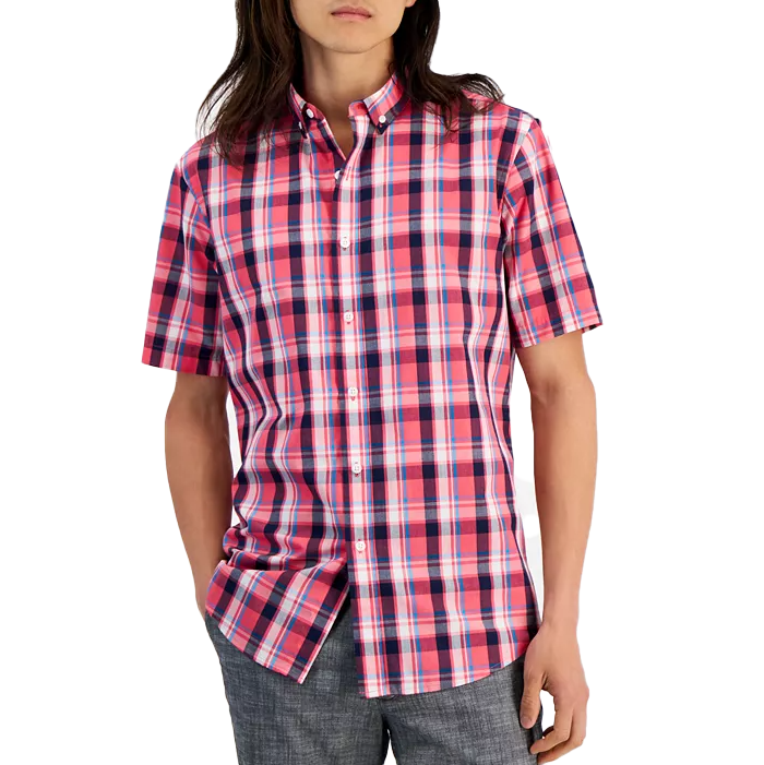 A short-sleeve, button-up, all-cotton shirt featuring a vibrant pink, navy, and white plaid pattern. The shirt has a classic collar and a relaxed fit, paired with gray pants.