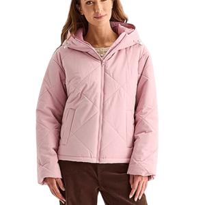 A woman wearing a light pink quilted hooded jacket with front pockets and a front zipper, paired with brown pants.