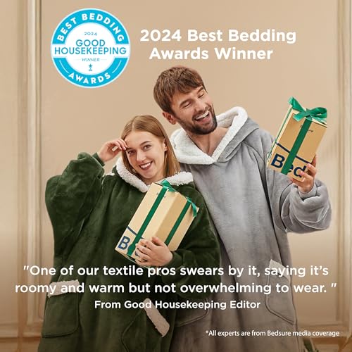 Two people smiling, wearing oversized hooded blankets while holding gift boxes. The image highlights the Good Housekeeping 2024 Best Bedding Award, emphasizing comfort and roominess.