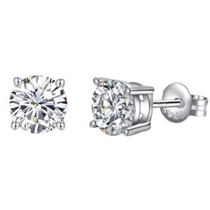 Silver & Moissanite stud earrings with a round-cut design set in a four-prong setting, featuring clear, sparkling stones on a post with a butterfly back. The metal is stamped with \“S925,\“ indicating sterling silver.