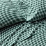 Green and white gingham pattern bedding set, including a pillowcase and sheet.