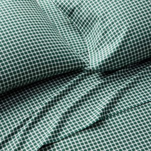 Green and white gingham pattern bedding set, including a pillowcase and sheet.