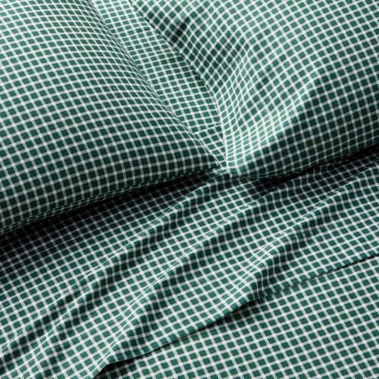 Green and white gingham pattern bedding set, including a pillowcase and sheet.