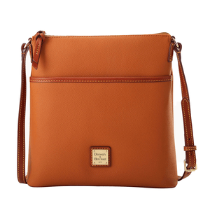 A tan crossbody leather bag with a front pocket, featuring an adjustable strap and a Dooney & Bourke brass logo plaque on the front.
