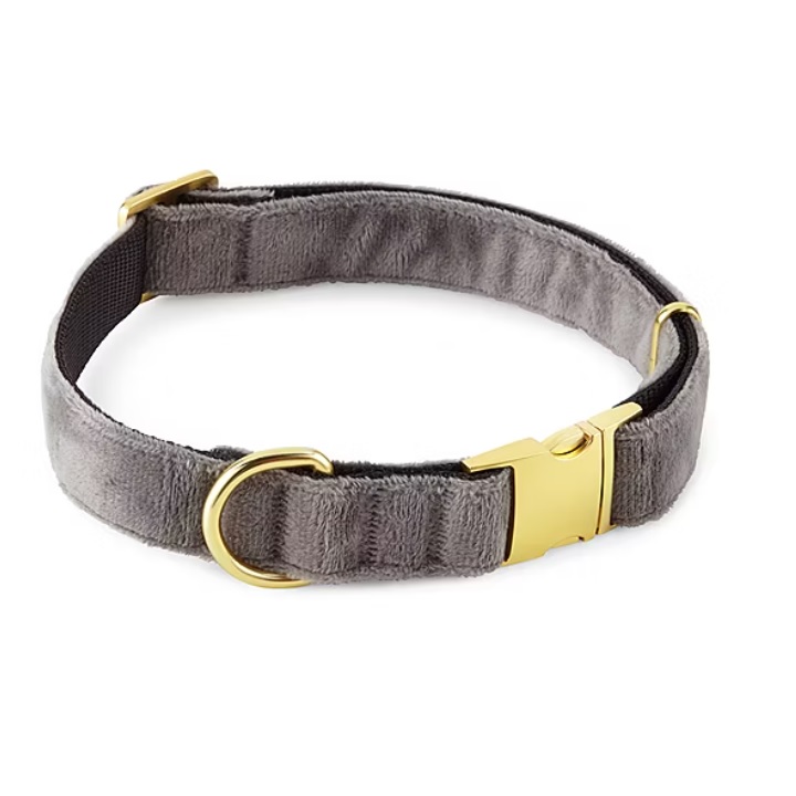 A gray velvet dog collar with gold hardware, featuring a secure buckle and a D-ring for attaching a leash or ID tags.