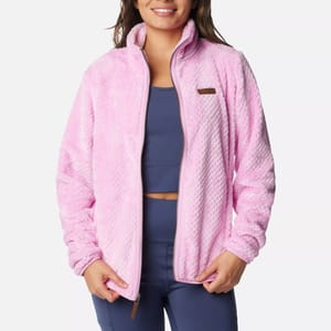 Woman in a pink fleece jacket with a high collar and navy blue athletic leggings.