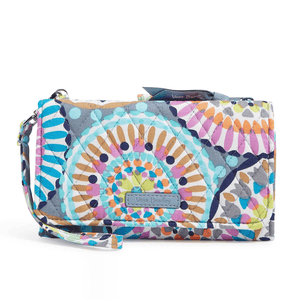A Vera Bradley wristlet with a colorful, patterned fabric design featuring a built-in RFID protection and a zipper closure. It has a detachable wrist strap for easy carrying.