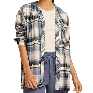 A person is wearing a plaid hooded button-up shirt layered over a white top, paired with blue drawstring pants.