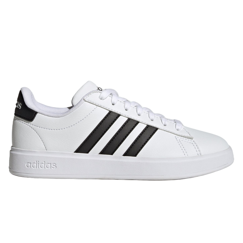 A white Adidas sneaker with three black stripes on the side and a textured sole.