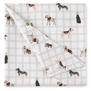 A beige grid-patterned bedsheet featuring various dogs wearing colorful sweaters.