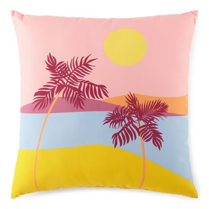 A decorative pillow featuring a colorful beach scene with two pink palm trees, a yellow sun, and abstract landscape elements in pastel shades of pink, blue, and yellow.