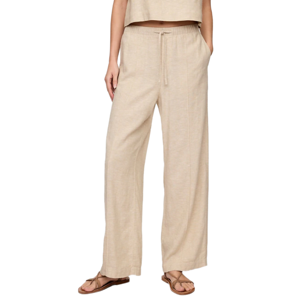 Beige wide-leg linen pants with an elastic waistband and drawstring, paired with flat sandals.