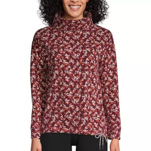 A floral-patterned, long-sleeve top with a cowl neck and drawstring detail at the hem, featuring a burgundy color scheme with small white flowers.
