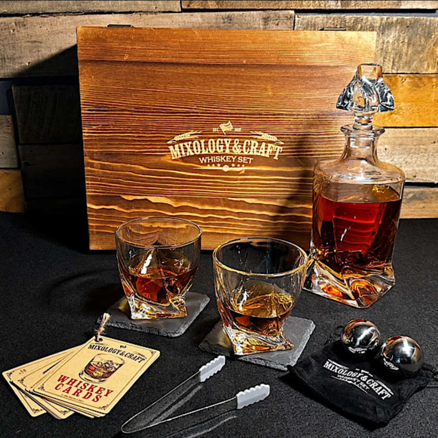 Whiskey set with two glasses, a decanter, chilling balls, tongs, coasters, and a wooden box.