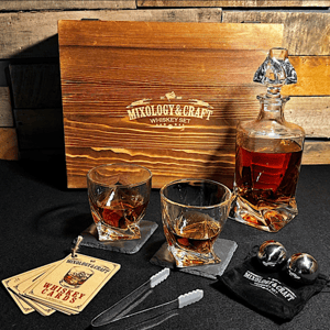 Whiskey set with two glasses, a decanter, chilling balls, tongs, coasters, and a wooden box.