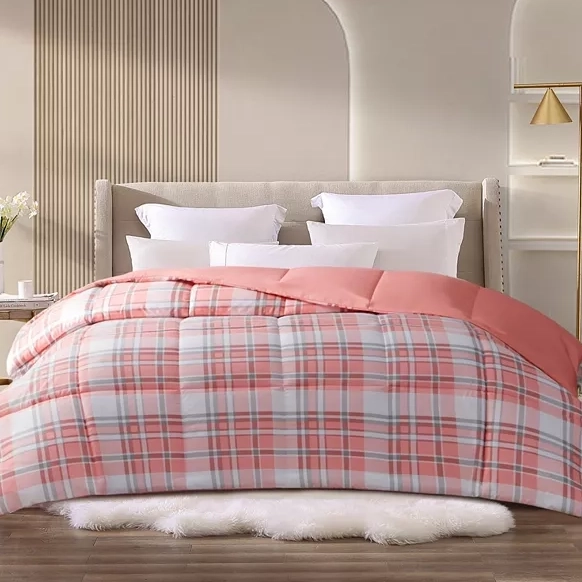 A bed with a beige headboard, pink and white plaid bedding, white pillows, and a furry white rug at the foot.
