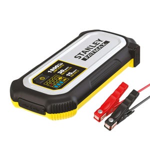 A compact, rectangular Stanley portable car jump starter with digital display and a pair of red and black clamps attached via cables.
