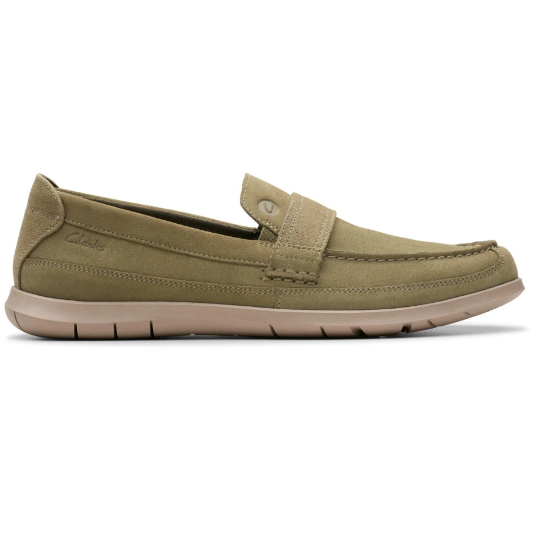 A beige slip-on loafer with a cushioned sole and stitched detailing, featuring a low profile and Clarks branding on the side.