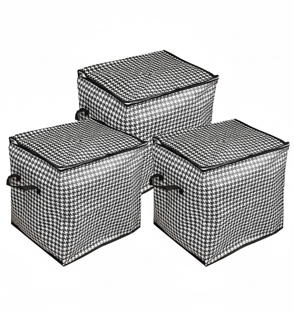 Three black and white houndstooth-patterned storage bags with handles, featuring zipper closures, are shown arranged together.