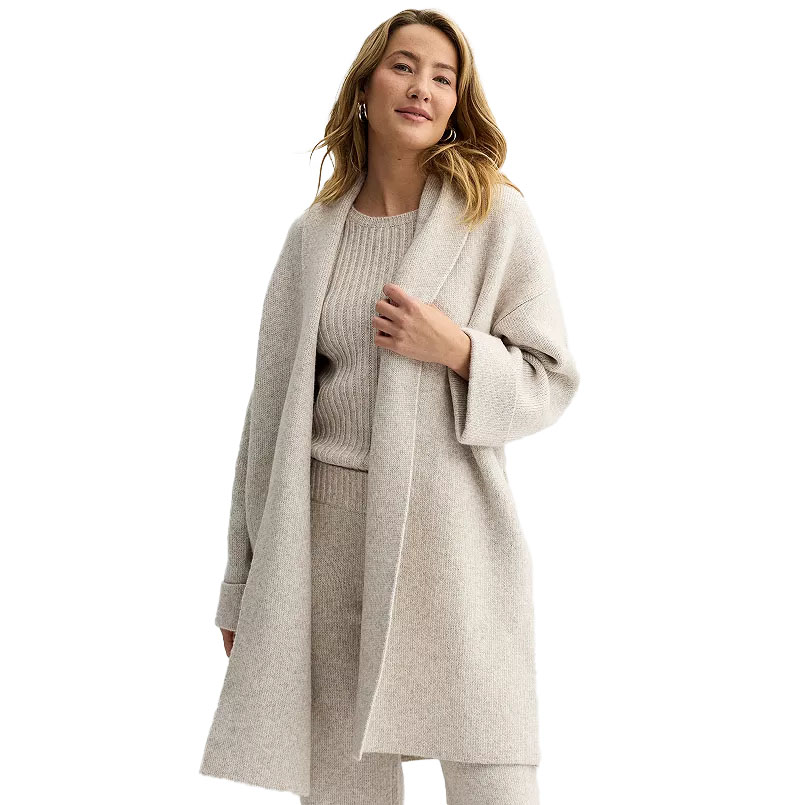 A woman is wearing a cozy, light gray Sonoma Shawl-Collar Duster Cardigan with a relaxed fit, featuring an open front and ribbed design, paired with matching ribbed sweater and pants.