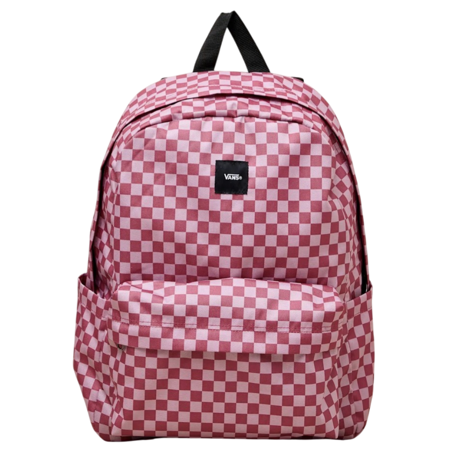 A pink and white checkered backpack from Vans with a front pocket, side pockets, and a top handle on a beige background.