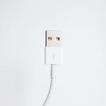 White USB cable against a plain background.